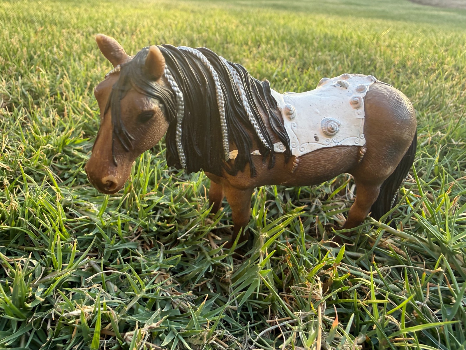 Schleich toy pony figure with decorated blanket and braided mane